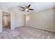 Cozy bedroom with carpeting, ceiling fan, and access to the hallway at 11094 Arcadia Sunrise Dr, Henderson, NV 89052