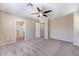 Inviting bedroom with carpet, ceiling fan, and an en-suite bathroom at 11094 Arcadia Sunrise Dr, Henderson, NV 89052