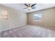 Spacious bedroom with neutral carpeting, ceiling fan, and natural light from windows at 11094 Arcadia Sunrise Dr, Henderson, NV 89052