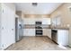 Modern kitchen with white cabinets, stainless steel appliances, and tile flooring at 11094 Arcadia Sunrise Dr, Henderson, NV 89052