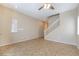 Spacious living area boasts neutral colors, tile floors, and an adjacent staircase at 11094 Arcadia Sunrise Dr, Henderson, NV 89052