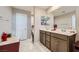 Bathroom with a double vanity, tile flooring, and white doors at 1111 Frye Mesa Ave, North Las Vegas, NV 89086