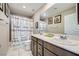 Bathroom with double vanity, mirror, and shower with a decorative curtain at 1111 Frye Mesa Ave, North Las Vegas, NV 89086