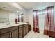 Primary bathroom features a dual sink vanity, shower/tub combo, and tile flooring at 1111 Frye Mesa Ave, North Las Vegas, NV 89086