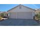 A two-car garage with light beige doors and stone accents at 1147 Light Sky Ave, Henderson, NV 89074