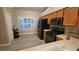 Kitchen with stainless appliances, wood cabinets, and a window with plantation shutters at 1147 Light Sky Ave, Henderson, NV 89074