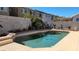 Refreshing pool with a private backyard, bordered by tropical plants, and complete with a stone wall at 1147 Light Sky Ave, Henderson, NV 89074