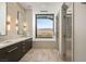 Bright bathroom featuring dual sinks, a soaking tub with a mountain view, and a glass-enclosed shower at 11660 Summit Club Dr # 204, Las Vegas, NV 89135