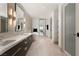 This bathroom features double vanity sinks and a luxurious soaking tub to the background of the relaxing bedroom at 11660 Summit Club Dr # 204, Las Vegas, NV 89135