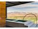 Relaxing hot tubs on a modern patio with a panoramic view of the desert and mountain range at 11660 Summit Club Dr # 204, Las Vegas, NV 89135