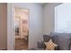 Bright bathroom featuring wood look floors, neutral paint, with stylish grey couch and star pillow at 12237 Plum Mist Ct # 4, Las Vegas, NV 89183