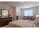 Inviting bedroom with a comfortable couch, stylish decor, and a view into the bathroom at 12237 Plum Mist Ct # 4, Las Vegas, NV 89183