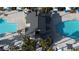 Aerial view of community pool with palm trees, lounge chairs, and shade structures at 12237 Plum Mist Ct # 4, Las Vegas, NV 89183