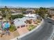 Stunning aerial view of a home boasting a pool, desert landscaping, and two-car garage against a mountain backdrop at 1409 Bonita Ave, Las Vegas, NV 89104