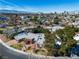 Aerial view of a single-story home boasting desert landscaping, pool, and mountain views at 1409 Bonita Ave, Las Vegas, NV 89104