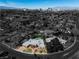 Stunning aerial view of a home with a private pool, lush landscaping, and a backdrop of the city skyline at 1409 Bonita Ave, Las Vegas, NV 89104