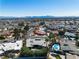 A desert home with palm trees, landscaping, and pool from an aerial view at 1409 Bonita Ave, Las Vegas, NV 89104