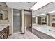 A marble countertop, soaking tub, and glass door shower in this bathroom at 1409 Bonita Ave, Las Vegas, NV 89104