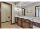 Bathroom featuring a large mirror, a vanity with a marble countertop, and stylish lighting fixtures at 1409 Bonita Ave, Las Vegas, NV 89104