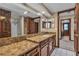 Bathroom featuring a marble countertop, dark wood cabinets, and a tiled shower at 1409 Bonita Ave, Las Vegas, NV 89104