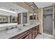 Marble counter tops, dual sinks, skylight, and tiled shower inside of bathroom at 1409 Bonita Ave, Las Vegas, NV 89104