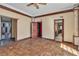 Bedroom with parquet floors and multiple entryways that lead to other parts of the house at 1409 Bonita Ave, Las Vegas, NV 89104