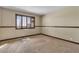 An empty bedroom with neutral walls, a brown trim, and a large shuttered window at 1409 Bonita Ave, Las Vegas, NV 89104