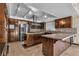 Updated kitchen featuring an island cooktop, stone countertops, and stainless steel appliances at 1409 Bonita Ave, Las Vegas, NV 89104