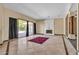 Bright living room featuring a statement fireplace, sliding glass doors, and marble floors at 1409 Bonita Ave, Las Vegas, NV 89104