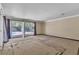 Living room with sliding glass doors leading to the backyard and swimming pool at 1409 Bonita Ave, Las Vegas, NV 89104