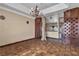 Open living room with a view into another room with an ornate chandelier and lots of storage space at 1409 Bonita Ave, Las Vegas, NV 89104