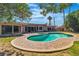 Inviting backyard with a kidney-shaped pool, surrounded by a brick-paved deck and lush landscaping at 1409 Bonita Ave, Las Vegas, NV 89104