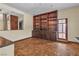 Cozy sitting area featuring wood floors, built-in bookshelves, and plenty of natural light at 1409 Bonita Ave, Las Vegas, NV 89104