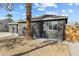 View of a single Gathering home featuring a gray exterior and easy to maintain gravel landscaping at 1417 Joshua Way, Las Vegas, NV 89101