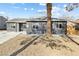 Single story home featuring gray exterior with well-kept gravel landscaping around a mature palm tree at 1417 Joshua Way, Las Vegas, NV 89101