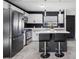 Modern kitchen featuring stainless steel appliances, island with seating, and contemporary lighting at 1417 Joshua Way, Las Vegas, NV 89101