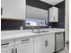 Bright kitchen featuring white cabinets, stainless steel appliances, and a window above the sink at 1417 Joshua Way, Las Vegas, NV 89101