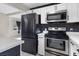 Kitchen with stainless steel appliances, white cabinetry, and modern fixtures at 1417 Joshua Way, Las Vegas, NV 89101