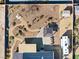 Aerial view of a house and desert landscaped yard with pond, shed, RV, patio and hot tub at 150 Spruce Ln, Pahrump, NV 89048