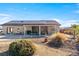 Home with a large backyard featuring desert landscaping, covered patio and solar panels at 150 Spruce Ln, Pahrump, NV 89048