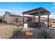 Enjoy the backyard with patio, hot tub, and desert landscaping at 150 Spruce Ln, Pahrump, NV 89048