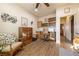 Bedroom area with wood-look tile flooring, a ceiling fan, a dresser, and a desk at 150 Spruce Ln, Pahrump, NV 89048