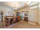 Cozy dining area with wood floors, a rustic dining table, and a stylish chandelier at 150 Spruce Ln, Pahrump, NV 89048