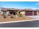 Attractive single-story home with desert landscaping, a three-car garage, and a covered front porch at 150 Spruce Ln, Pahrump, NV 89048