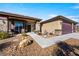 Attractive single-story home with desert landscaping, a three-car garage, and a covered front porch at 150 Spruce Ln, Pahrump, NV 89048