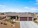 Beautiful single-story home featuring a spacious three-car garage, desert landscaping, and a welcoming front porch at 150 Spruce Ln, Pahrump, NV 89048