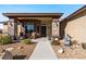 Charming front porch with stylish stone pillars, seating, desert landscaping, and a secure front door at 150 Spruce Ln, Pahrump, NV 89048