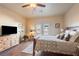 Bedroom with wood-look flooring, a ceiling fan, a dresser, and a doorway to the backyard at 150 Spruce Ln, Pahrump, NV 89048