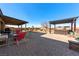 Spacious patio area with pergola, hot tub, and desert landscaping provides an excellent outdoor living space at 150 Spruce Ln, Pahrump, NV 89048