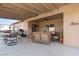 Covered patio includes wicker furniture, ceiling fan and lights, and a view of the spacious backyard at 150 Spruce Ln, Pahrump, NV 89048